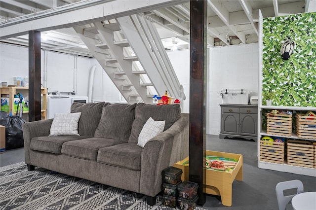 living room featuring washer and dryer and concrete flooring