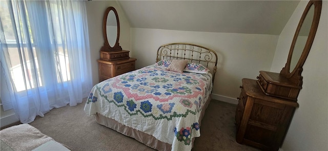 carpeted bedroom with lofted ceiling