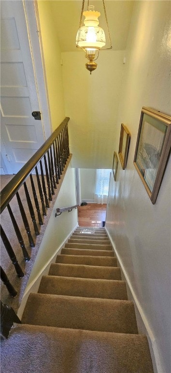 stairs featuring carpet flooring