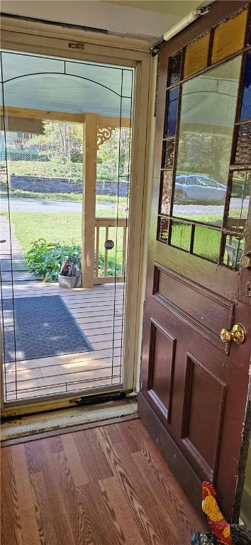 doorway to outside with hardwood / wood-style floors and a wealth of natural light