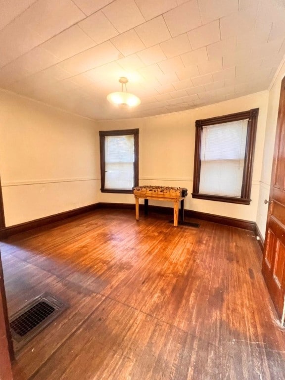 unfurnished room with hardwood / wood-style floors