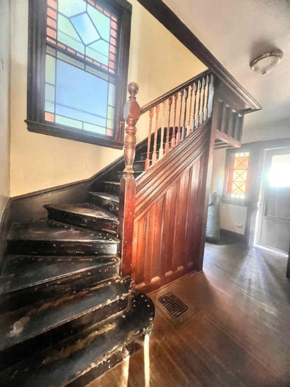 staircase with hardwood / wood-style floors