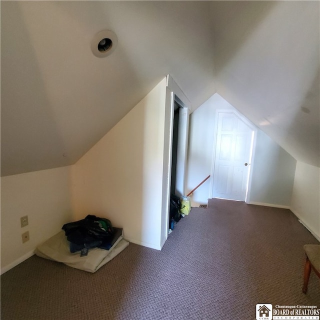 bonus room featuring lofted ceiling and carpet