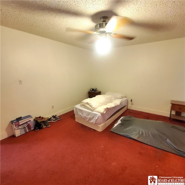 unfurnished bedroom with ceiling fan, a textured ceiling, and carpet floors