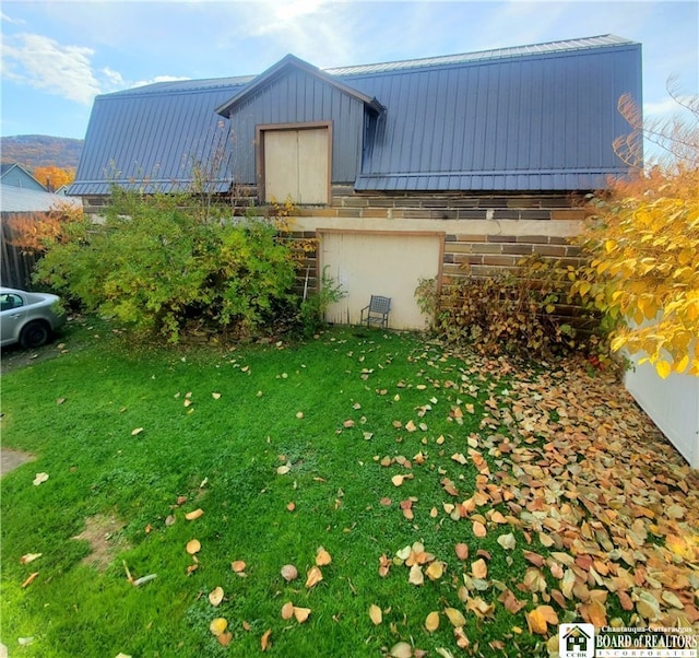 view of property exterior featuring a lawn