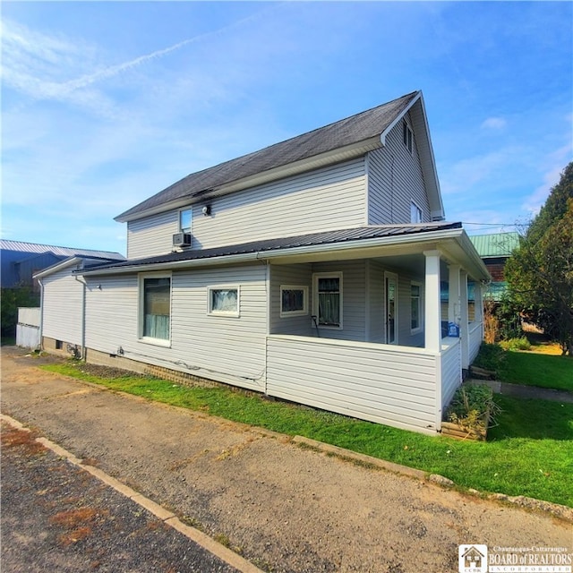 view of side of home featuring cooling unit