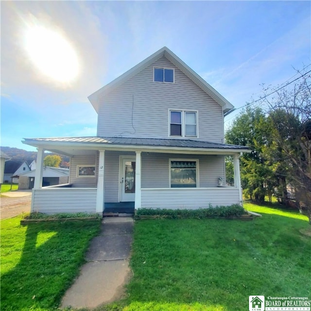 view of front of property with a front yard and covered porch