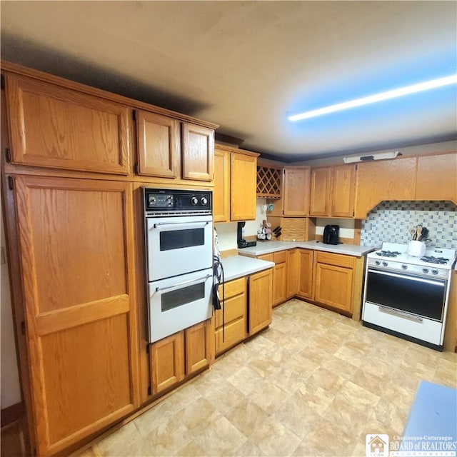 kitchen with white appliances and decorative backsplash