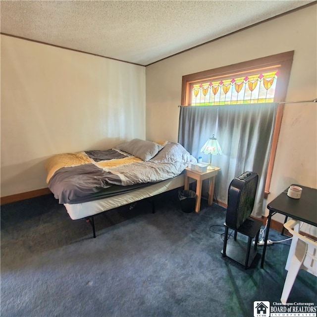 carpeted bedroom featuring a textured ceiling