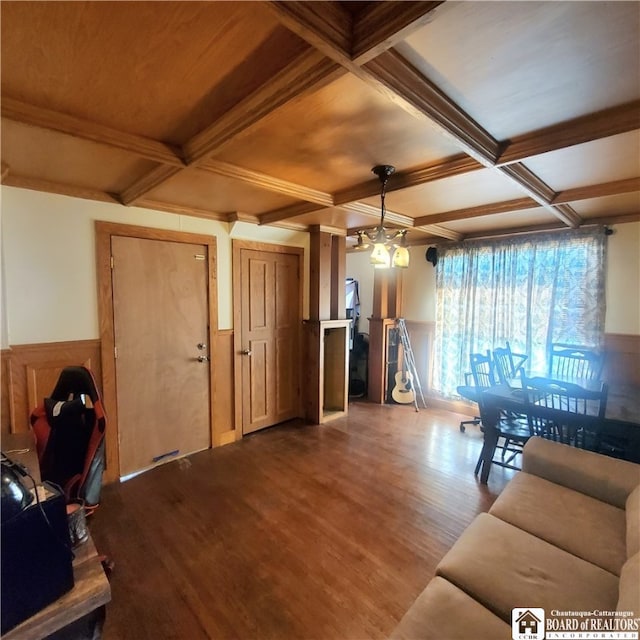 living room featuring coffered ceiling, beamed ceiling, and hardwood / wood-style floors