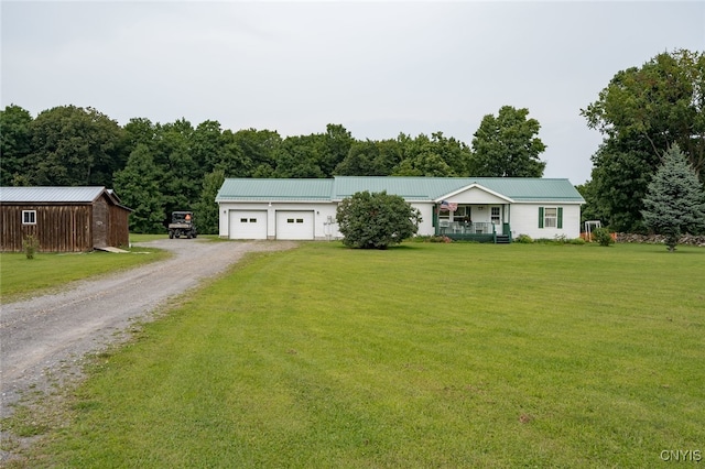 ranch-style home with a garage, covered porch, and a front lawn