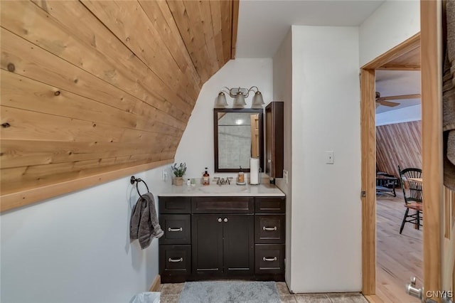 bathroom featuring wood ceiling, wood-type flooring, vaulted ceiling, vanity, and ceiling fan