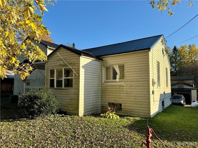 view of property exterior with a lawn