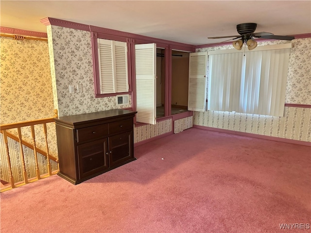 unfurnished living room with crown molding, carpet, and ceiling fan