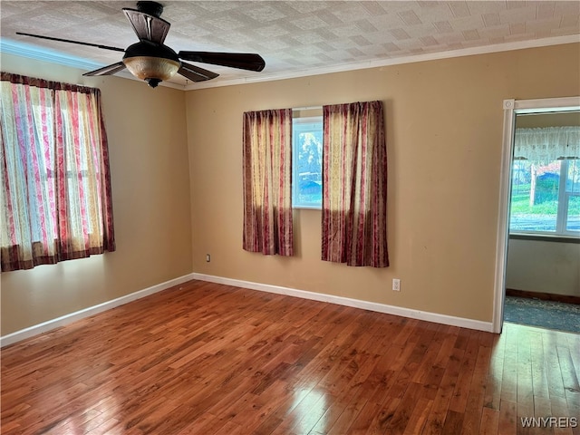 unfurnished room featuring crown molding, wood-type flooring, a textured ceiling, and ceiling fan