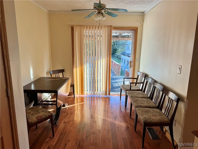 sitting room with ceiling fan, a textured ceiling, ornamental molding, and hardwood / wood-style floors