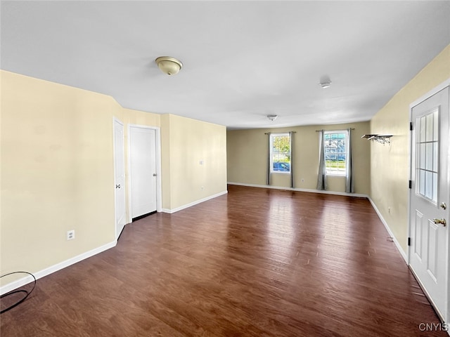 unfurnished room featuring dark hardwood / wood-style flooring