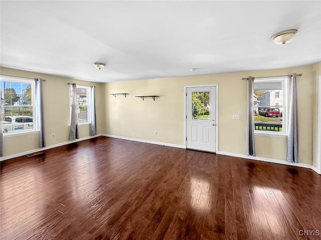 unfurnished room with dark hardwood / wood-style floors