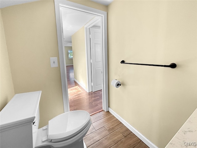 bathroom with wood-type flooring and toilet