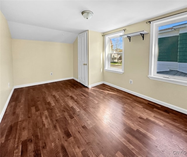 bonus room featuring lofted ceiling and dark hardwood / wood-style floors