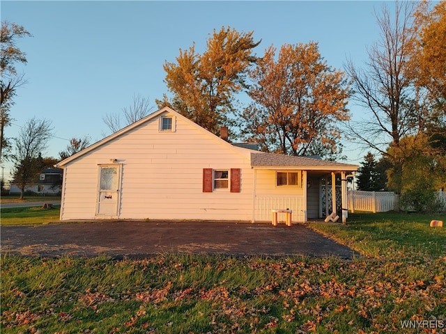 back of property with a lawn