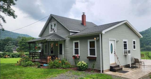 rear view of property with a yard