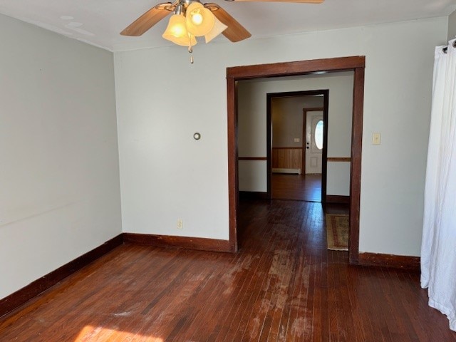 spare room featuring ceiling fan and dark hardwood / wood-style flooring