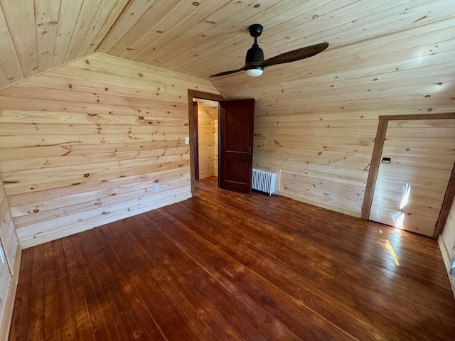 bonus room with wood ceiling, hardwood / wood-style flooring, radiator, vaulted ceiling, and wooden walls