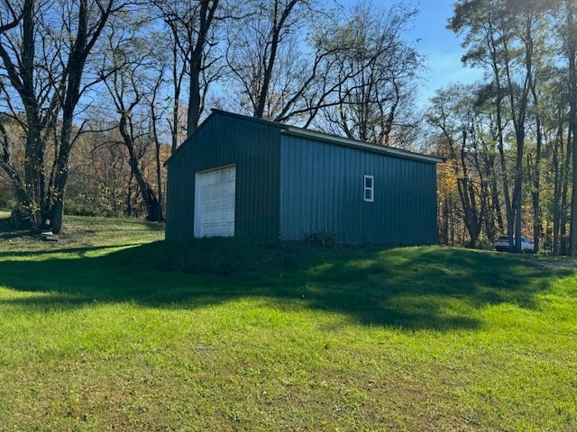 view of outdoor structure with a yard and a garage