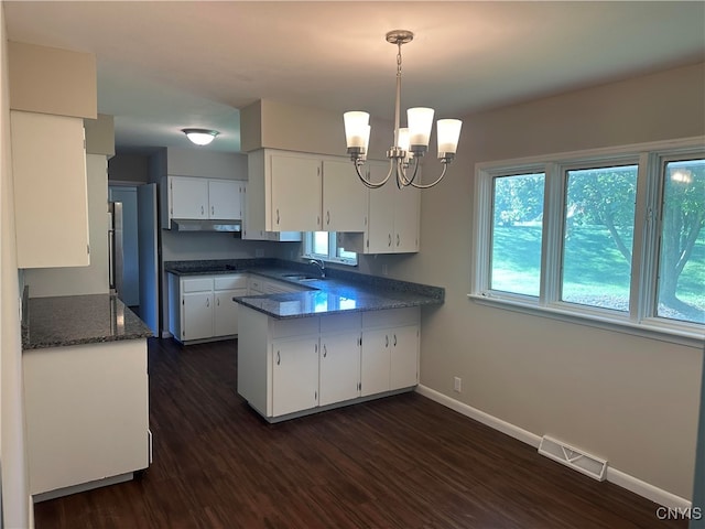 kitchen with white cabinetry, sink, and a wealth of natural light