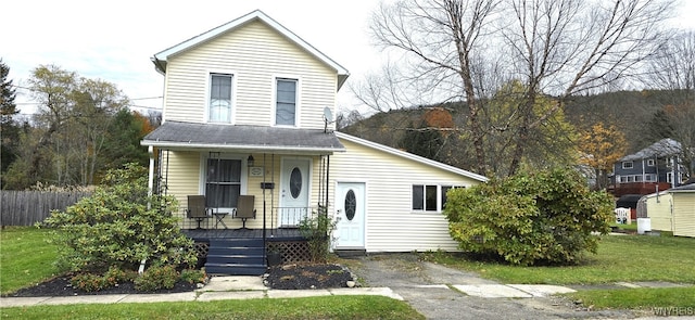 view of front facade with covered porch and a front lawn