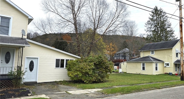 view of property exterior with a lawn