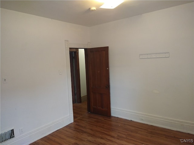 unfurnished room featuring dark hardwood / wood-style flooring