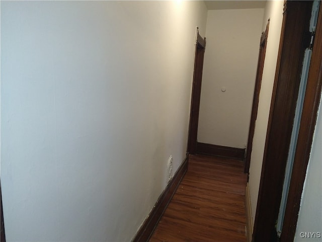 hallway with dark wood-type flooring