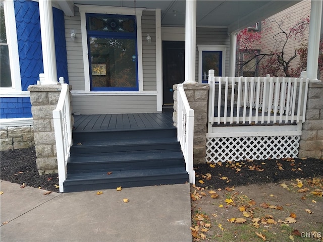 doorway to property featuring covered porch