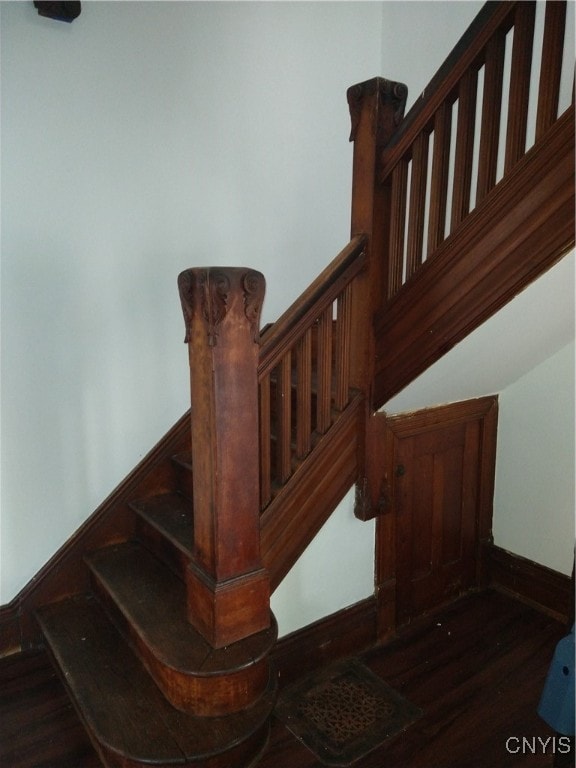 staircase with hardwood / wood-style floors