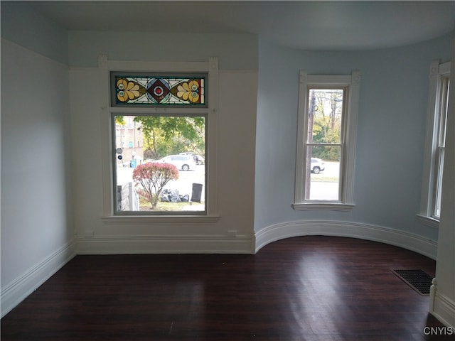 spare room with dark hardwood / wood-style flooring