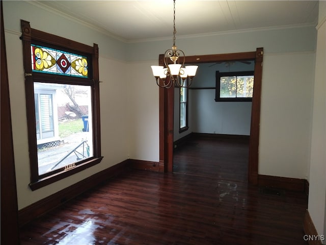 unfurnished dining area with a notable chandelier, dark hardwood / wood-style floors, and crown molding