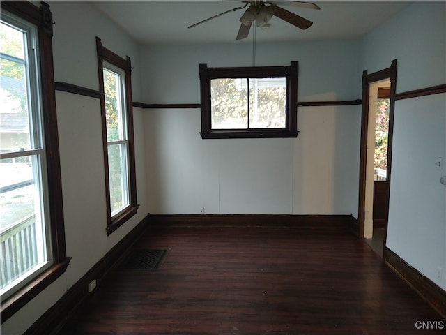 unfurnished room featuring dark hardwood / wood-style floors, plenty of natural light, and ceiling fan