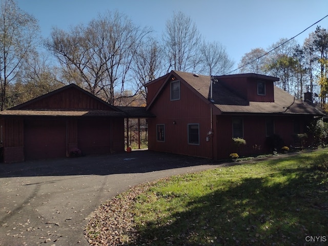 view of side of property with a lawn