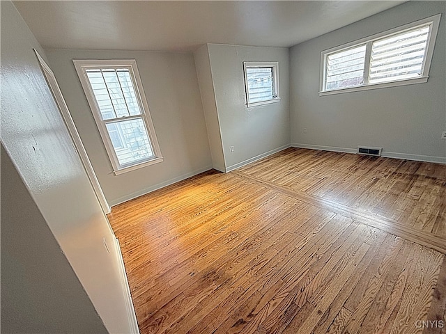 empty room with light hardwood / wood-style flooring