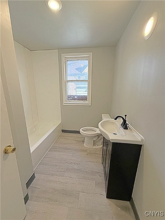 bathroom with vanity, toilet, a shower, and hardwood / wood-style floors