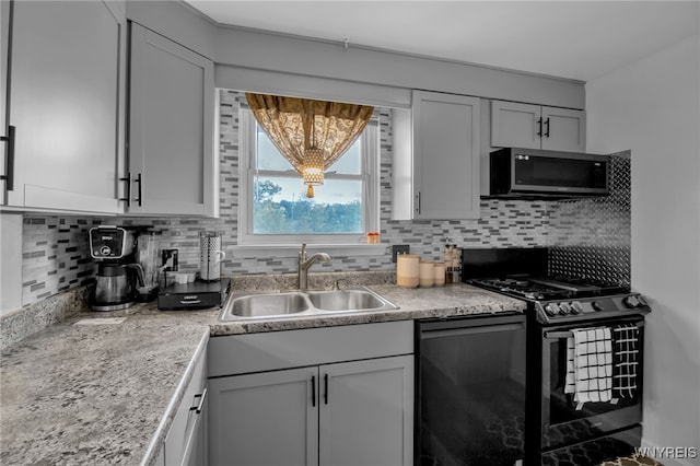 kitchen featuring black appliances, sink, and backsplash