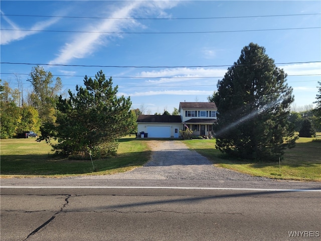 view of front facade featuring a front yard and a garage