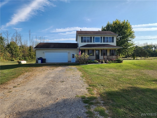 view of front of property with covered porch, a garage, and a front lawn