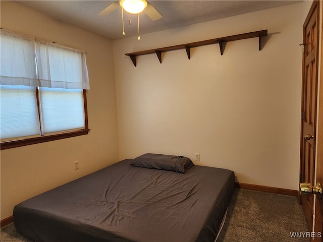 bedroom featuring dark colored carpet and ceiling fan