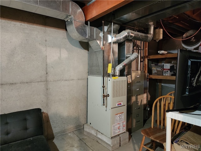 utility room featuring heating unit