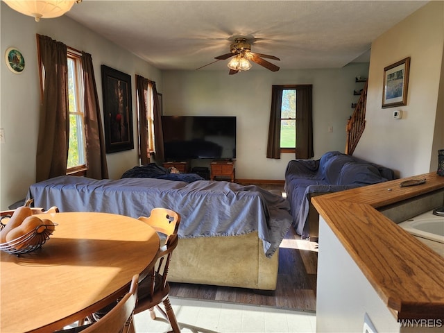 living room featuring ceiling fan and light wood-type flooring