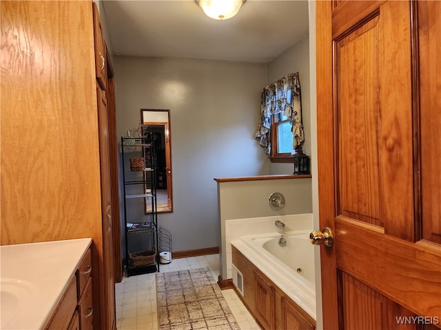 bathroom with vanity and a washtub