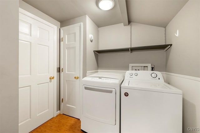 washroom with light hardwood / wood-style floors and separate washer and dryer